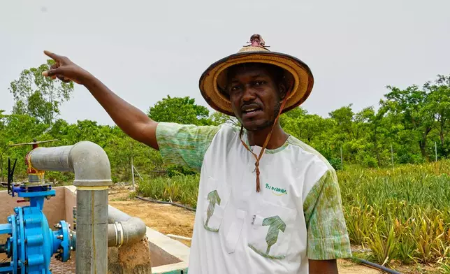 Farmer Oumarou Compaoré speaks to the Associated Press as he stands by one of the irrigation systems at Djoda Farm in Matourkou, near Bobo-Dioulasso, Burkina Faso, Thursday, May 7, 2026. (AP Photo/Elia Borras)
