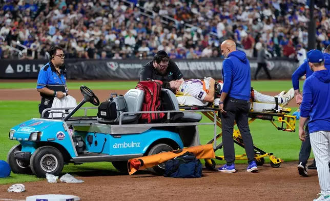 New York Mets first baseman Jared Young is brought off the field on a stretcher after colliding with pitcher Nolan McLean during the sixth inning of a baseball game against the Philadelphia Phillies, Thursday, Sept. 17, 2026, in New York. (AP Photo/Seth Wenig)