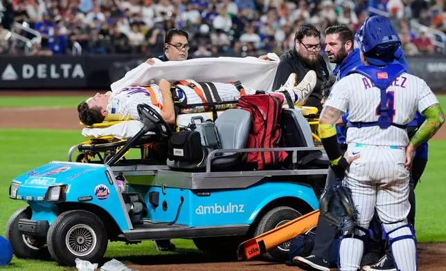 New York Mets first baseman Jared Young is brought off the field on a stretcher after colliding with pitcher Nolan McLean during the sixth inning of a baseball game against the Philadelphia Phillies, Thursday, Sept. 17, 2026, in New York. (AP Photo/Seth Wenig)