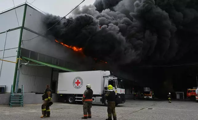 Firefighters put out a fire at warehouse stores after a Russian air attack in Odesa, Ukraine, Sunday, Sept. 13, 2026. (AP Photo/Michael Shtekel)