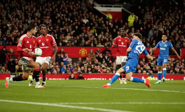 Brighton's Maxim De Cuyper, front right, scores his side's third goal during the English League Cup third round soccer match between Manchester United and Brighton and Hove Albion in Manchester, England, Wednesday, Sept. 16, 2026. (AP Photo/Dave Thompson)