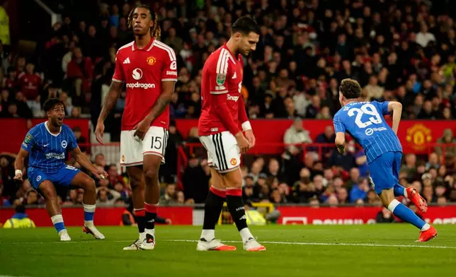 Brighton's Maxim De Cuyper, right, celebrates after scoring his side's third goal during the English League Cup third round soccer match between Manchester United and Brighton and Hove Albion in Manchester, England, Wednesday, Sept. 16, 2026. (AP Photo/Dave Thompson)