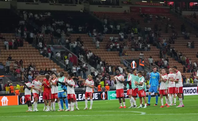 Benfica players celebrate at the end of the Europa League opening phase soccer match between AC Milan and Benfica in Milan, Italy, Wednesday, Sept. 16, 2026. (AP Photo/Antonio Calanni)
