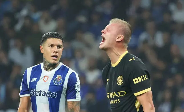 Manchester City's Erling Haaland reacts after a missed chance to score, next to Porto's Nehuen Perez, left, during a Champions League opening phase soccer match between FC Porto and Manchester City in Porto, Portugal, Tuesday, Sept. 8, 2026. (AP Photo/Luis Vieira)