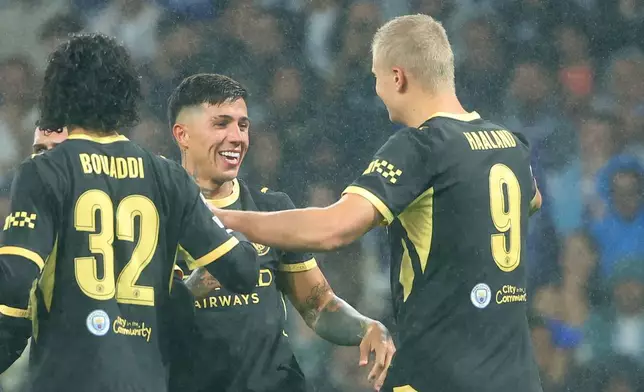 Erling Haaland, right, celebrates with Enzo Fernandez after scoring the opening goal during a Champions League opening phase soccer match between FC Porto and Manchester City in Porto, Portugal, Tuesday, Sept. 8, 2026. (AP Photo/Luis Vieira)