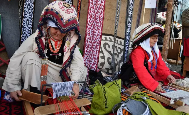 Kyrgyz women display their craftsmanship skills during at the World Nomad Games in Kyrchyn Gorge, 240 kilometers (150 miles) southeast of Bishkek, Kyrgyzstan, on Thursday, Sept. 3, 2026, with yurts in the background. (AP Photo/Vladimir Voronin)