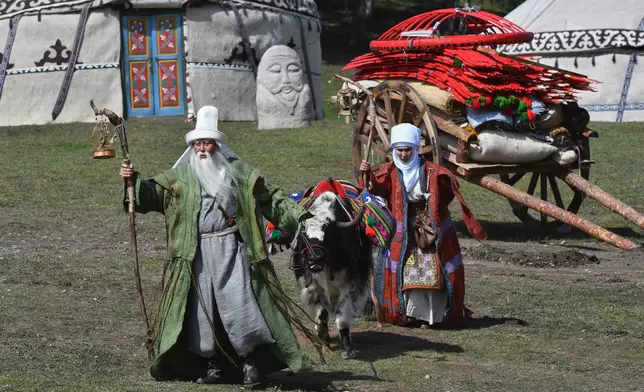 Kyrgyz actors dressed in national Kyrgyz costumes perform prior to the horse-riding competition at the World Nomad Games in Kyrchyn Gorge, 240 km (150 miles) southeast of Bishkek, Kyrgyzstan, Wednesday, Sept. 2, 2026. (AP Photo/Vladimir Voronin)
