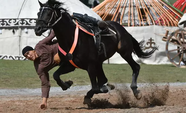 A participant shows his skills as he takes part in the horse-riding competition during the World Nomad Games in Kyrchyn Gorge, 240 km (150 miles) southeast of Bishkek, Kyrgyzstan, Wednesday, Sept. 2, 2026. (AP Photo/Vladimir Voronin)