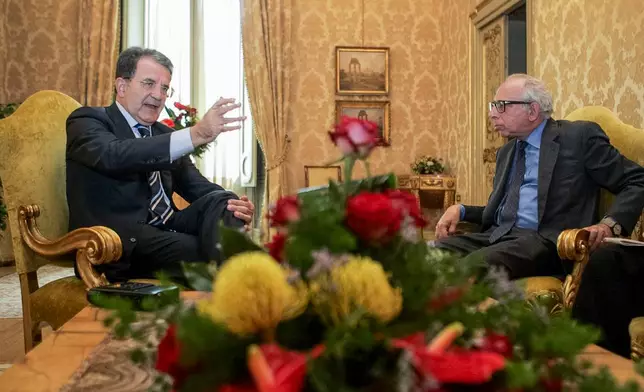 FILE - Italian Premier Romano Prodi, left, gestures as he is interviewed by Associated Press Rome Bureau Chief Victor Simpson at Chigi palace, in Rome, Wednesday, July 26, 2006. (AP Photo/Domenico Stinellis, File)