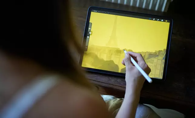 Illustrator Marina Antonova works on a drawing for her series called "Chronicles of a Heating Planet" in Beaumont-les-Valence, southern France, on Sept. 12, 2026. (AP Photo/Laurent Cipriani)