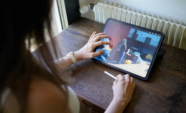 Illustrator Marina Antonova works on a drawing for her series called "Chronicles of a Heating Planet" in Beaumont-les-Valence, southern France, on Sept. 12, 2026. (AP Photo/Laurent Cipriani)