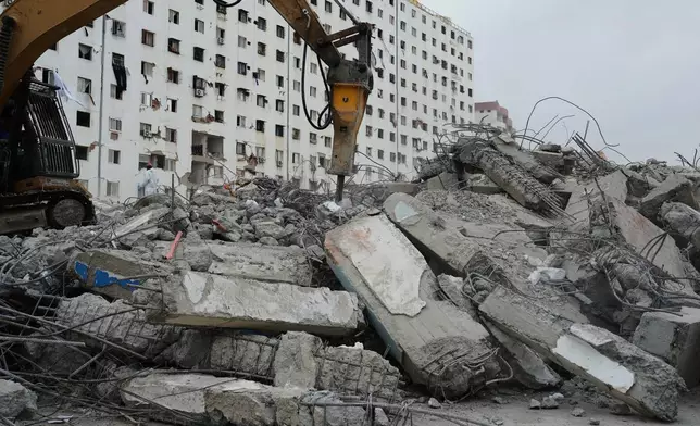 FILE - A hydraulic hammer breaks apart columns at an O-P-P housing tower that was built as part of a government program and collapsed during twin earthquakes in Caraballeda, La Guaira, Venezuela, July 17, 2026. (AP Photo/Ariana Cubillos, File)