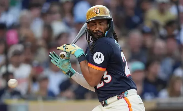 San Diego Padres' Fernando Tatis Jr. moves away from an inside pitch while batting during the first inning of a baseball game against the New York Yankees Friday, Sept. 4, 2026, in San Diego. (AP Photo/Gregory Bull)