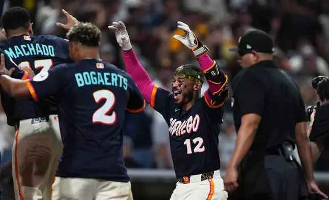 San Diego Padres' Luis Campusano celebrates with teammates after hitting a two-run, walk off home run during the tenth inning of a baseball game against the New York Yankees Friday, Sept. 4, 2026, in San Diego. (AP Photo/Gregory Bull)