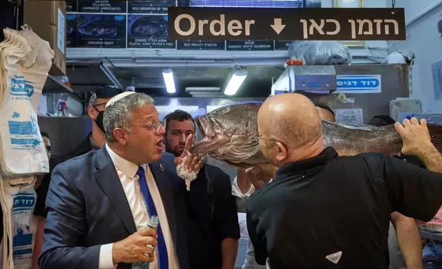 Israel's National Security Minister Itamar Ben-Gvir, left, visits the Mahane Yehuda market in Jerusalem, Wednesday, Sept. 9, 2026, as part of his party's campaign ahead of Israel's general election. (AP Photo/Ohad Zwigenberg)