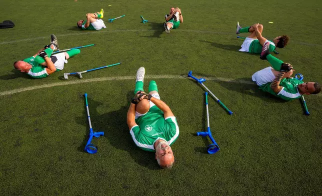 Panathinaikos' players warm-up before an amputee soccer match between FCSB and Panathinaikos in the inaugural EAFF Conference League in Bucharest, Romania, Friday, Sept. 25, 2026. (AP Photo/Andreea Alexandru)