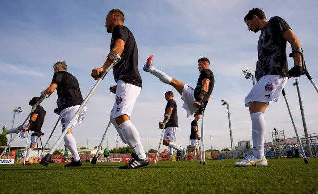 FCSB's players warm-up before an amputee soccer match between FCSB and Panathinaikos in the inaugural EAFF Conference League in Bucharest, Romania, Friday, Sept. 25, 2026. (AP Photo/Andreea Alexandru)