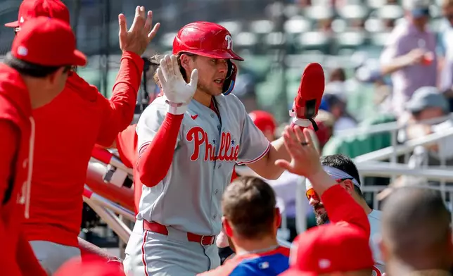Philadelphia Phillies' Alec Bohm celebrates in the dugout after scoring against the Atlanta Braves during the eighth inning of a baseball game, Sunday, Sept. 13, 2026, in Atlanta. (AP Photo/Erik S. Lesser)