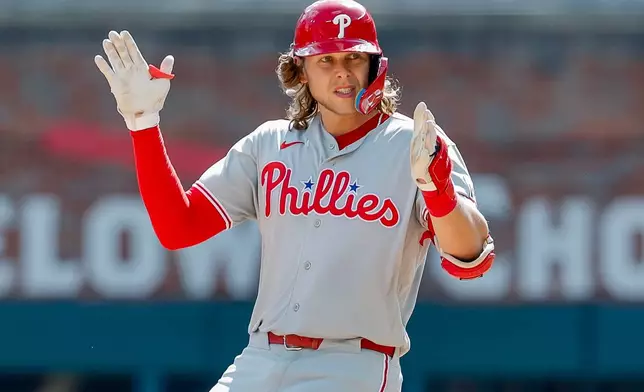 Philadelphia Phillies' Alec Bohm reacts after hitting a two-run double against the Atlanta Braves during the eighth inning of a baseball game, Sunday, Sept. 13, 2026, in Atlanta. (AP Photo/Erik S. Lesser)