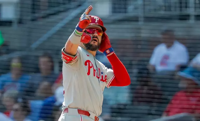 Philadelphia Phillies designated hitter Kyle Schwarber reacts after hitting a two-run single against the Atlanta Braves during the eighth inning of a baseball game, Sunday, Sept. 13, 2026, in Atlanta. (AP Photo/Erik S. Lesser)