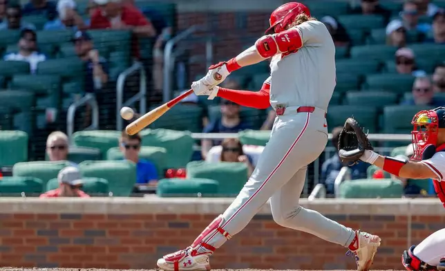Philadelphia Phillies' Alec Bohm hits a two-run double against the Atlanta Braves during the eighth inning of a baseball game, Sunday, Sept. 13, 2026, in Atlanta. (AP Photo/Erik S. Lesser)