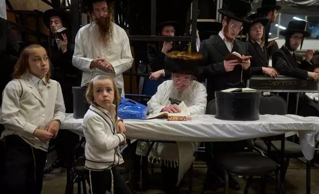 Ultra-Orthodox Jewish men pray ahead of Yom Kippur, which begins at sunset, in Beit Shemesh, Israel, Sunday, Sept. 20, 2026. (AP Photo/Ohad Zwigenberg)