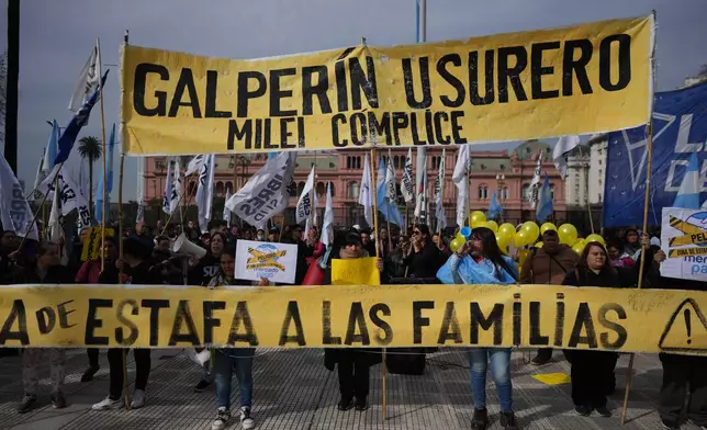 Demonstrators hold a banner with a message that reads in Spanish: "Galperin loan shark, Milei an accomplice" outside the Economy Ministry to demand government action over a household debt crisis in Buenos Aires, Argentina, Thursday, Aug. 20, 2026. (AP Photo/Victor R. Caivano, File)