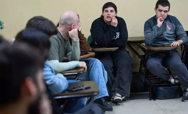 University students meet in a classroom to discuss debt in Buenos Aires, Argentina, Wednesday, Aug. 26, 2026. (AP Photo/Rodrigo Abd)