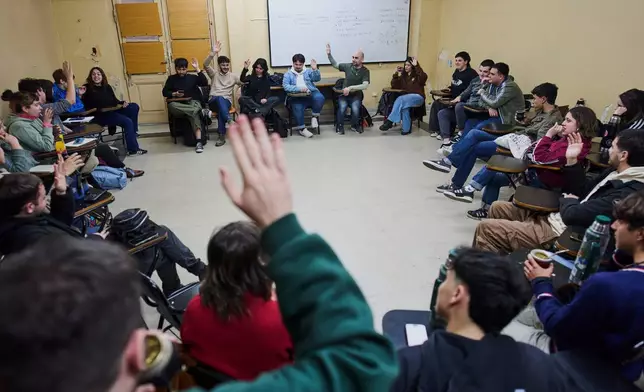 University students meet in a classroom to discuss debt in Buenos Aires, Argentina, Wednesday, Aug. 26, 2026. (AP Photo/Rodrigo Abd)