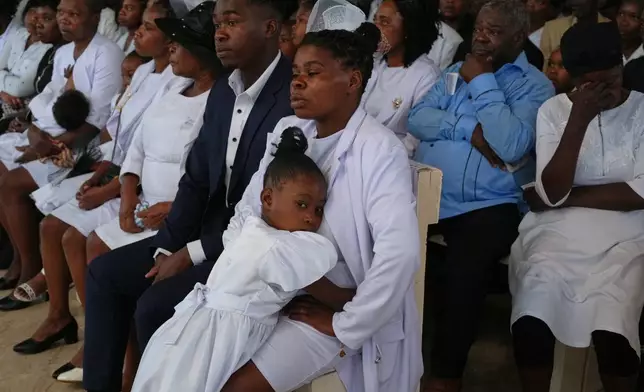 Relatives attend the funeral service for victims of a gang attack in the Kenscoff neighborhood of Port-au-Prince, Haiti, Wednesday, Sept. 2, 2026. (AP Photo/Odelyn Joseph)