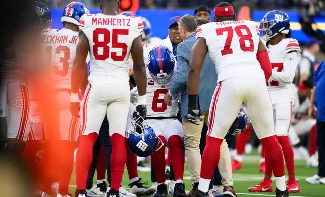 New York Giants quarterback Jaxson Dart (6) is helped up after getting injured during an NFL football game against the Los Angeles Rams in Inglewood, Calif., Monday, Sept. 21, 2026. (AP Photo/Kyusung Gong)