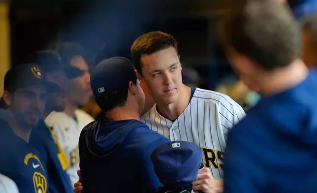 Milwaukee Brewers pitcher Jacob Misiorowski, center right, hugs teammate Logan Henderson, center left, after exiting to a standing ovation in the sixth inning of a baseball game against the St. Louis Cardinals, Sunday, Sept. 27, 2026, in Milwaukee. (AP Photo/Kayla Wolf)