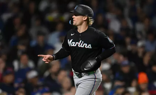Miami Marlins' Kyle Stowers celebrates after scoring on a Agustin Ramirez single during the fourth inning of a baseball game against the Chicago Cubs Tuesday, Sept. 22, 2026, in Chicago. (AP Photo/Paul Beaty)