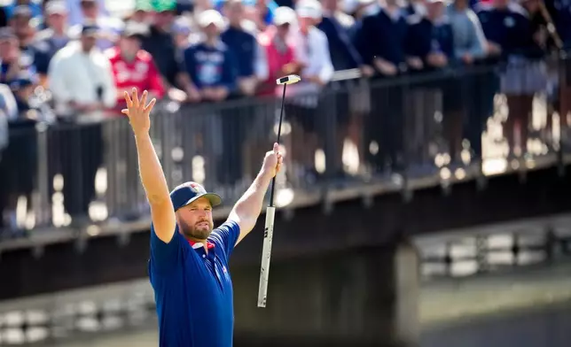 USA teams' Wyndham Clark reacts to teammate Collin Morikawa's shot on the 12th green against the International team during a Presidents Cup golf tournament third round four-ball match at Medinah Country Club, Saturday, Sept. 26, 2026, in Medinah, Ill. (AP Photo/Matt Slocum)