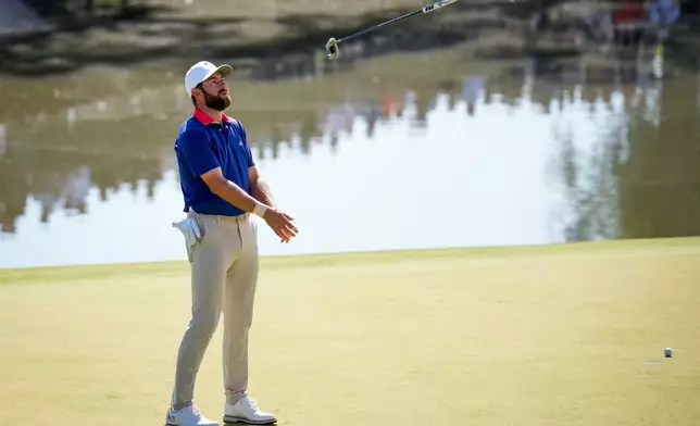 USA teams' Cameron Young reacts to his missed shot on the 12th green against the International team during a Presidents Cup golf tournament third round four-ball match at Medinah Country Club, Saturday, Sept. 26, 2026, in Medinah, Ill. (AP Photo/Matt Slocum)