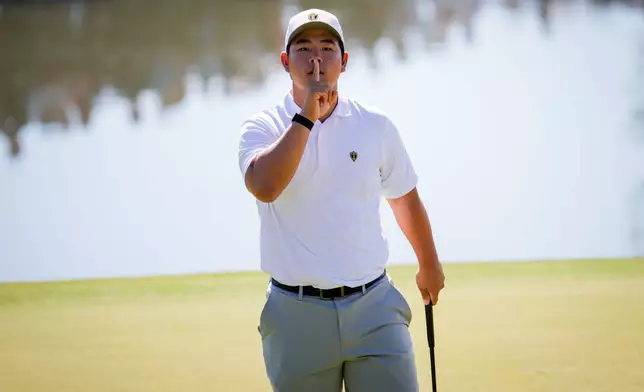 International teams' Tom Kim, of South Korea, reacts after his shot on the 12th green against the USA team during a Presidents Cup golf tournament third round four-ball match at Medinah Country Club, Saturday, Sept. 26, 2026, in Medinah, Ill. (AP Photo/Matt Slocum)