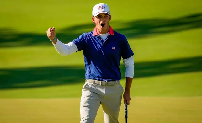 USA teams' Jackson Koivun celebrates his shot on the eighth green against the International teams' during a Presidents Cup golf tournament third round four-ball match at Medinah Country Club, Saturday, Sept. 26, 2026, in Medinah, Ill. (AP Photo/Chris Carlson)