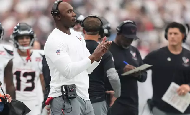 Houston Texans head coach DeMeco Ryans applauds from the sidelines during the first half of an NFL football game against the Buffalo Bills, Sunday, Sept. 13, 2026, in Houston. (AP Photo/Ashley Landis)