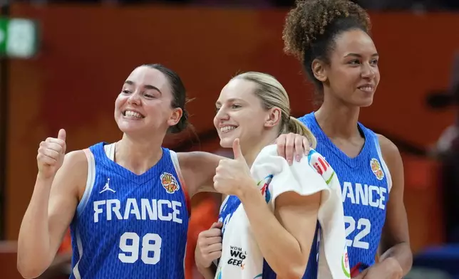 France's Pauline Astier, left, and France's Marine Johannes react after the Women's Basketball World Cup quarterfinal match between the China and France in Berlin, Thursday, Sept. 10, 2026. (AP Photo/Ebrahim Noroozi)