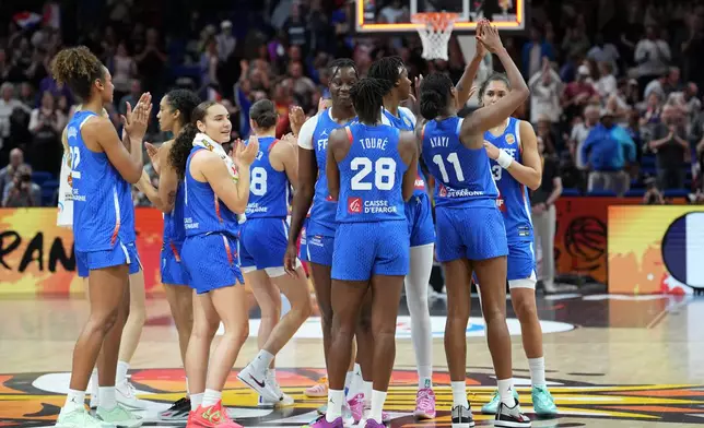 French players wave to fans after the Women's Basketball World Cup quarterfinal match between the China and France in Berlin, Thursday, Sept. 10, 2026. (AP Photo/Ebrahim Noroozi)