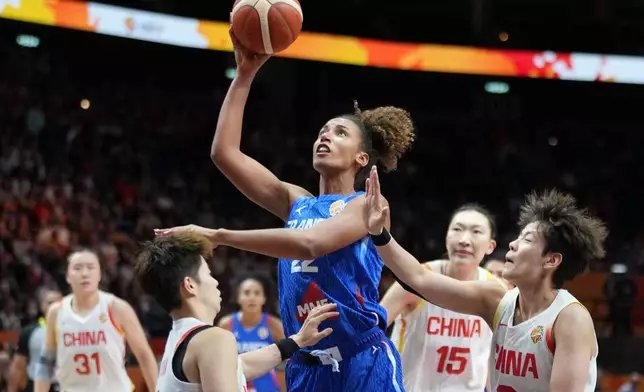 France's Marième Badiane shoots over China's Li Yuan during the Women's Basketball World Cup quarterfinal match between the China and France in Berlin, Thursday, Sept. 10, 2026. (AP Photo/Ebrahim Noroozi)