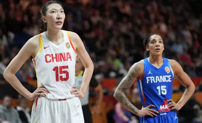 China's Han Xu and France's Gabby Williams wait for freethrows during the Women's Basketball World Cup quarterfinal match between the China and France in Berlin, Thursday, Sept. 10, 2026. (AP Photo/Ebrahim Noroozi)