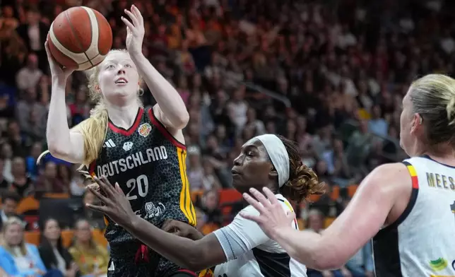 Germany's Frieda Buhner shoots over Belgium's Bethy Mununga during the Women's Basketball World Cup quarterfinal match between Germany and Belgium in Berlin, Thursday, Sept. 10, 2026. (AP Photo/Ebrahim Noroozi)