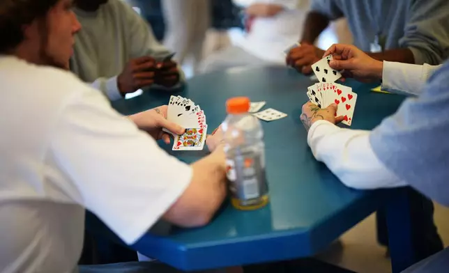 People who are incarcerated play cards at a Minnesota Correctional Facility in Lino Lakes, Minn., Tuesday, Sept. 15, 2026. (AP Photo/Ellen Schmidt)