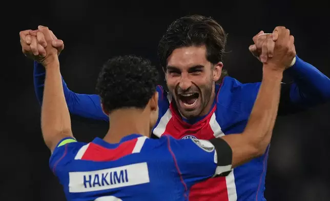 PSG's Ferran Torres celebrates with PSG's Achraf Hakimi after scoring during the Champions League opening phase soccer match between PSG and Slovan Bratislava in Paris, Wednesday, Sept. 9, 2026. (AP Photo/Thibault Camus)