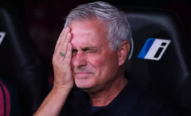 Real Madrid head coach Jose Mourinho gestures while sitting on the bench during the Spanish La Liga soccer match between Real Madrid and Rayo Vallecano in Madrid, Spain, Saturday, Sept. 12, 2026. (AP Photo/Manu Fernandez)