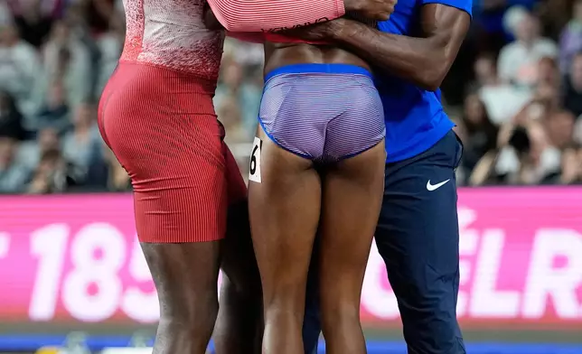Melissa Jefferson-Wooden, of the United States, celebrates with sprinters Aaron Brown, of Canada, left, and Kenneth Bednarek, of the United States, after winning the women's 200 meters final at the World Athletics Ultimate Championship in Budapest, Hungary, Sunday, Sept. 13, 2026. (AP Photo/Matthias Schrader)