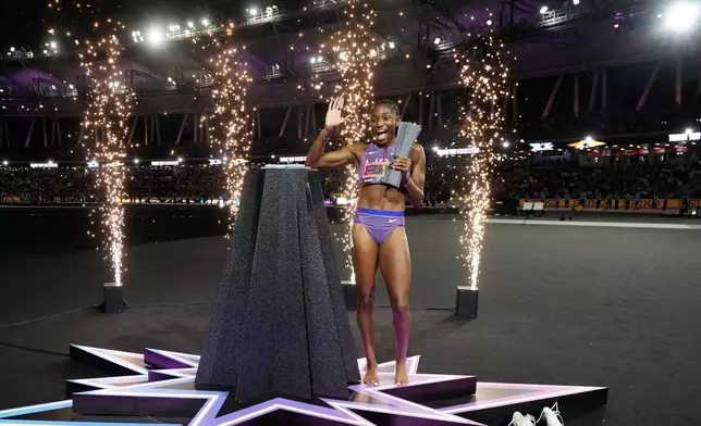 Melissa Jefferson-Wooden, of the United States, poses with her trophy after winning the women's 200 meters final at the World Athletics Ultimate Championship in Budapest, Hungary, Sunday, Sept. 13, 2026. (AP Photo/Matthias Schrader)