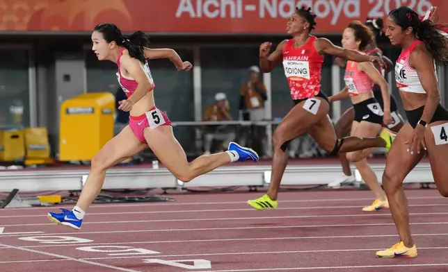 China's Chen Yujie crosses the finish line ahead of others in the women's 100-meter final at the Asian Games in Nagoya, Japan, Friday, Sept. 25, 2026. (AP Photo/Aaron Favila)