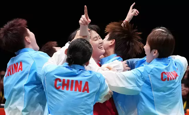 China's team celebrate after winning against Japan during the women's badminton team finals at the Asian Games in Ichinomiya City, Japan, Thursday, Sept. 24, 2026. (AP Photo/Aaron Favila)